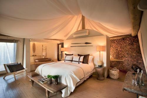 a bedroom with a large bed in a tent at Marataba Safari Lodge in Hartbeestfontein