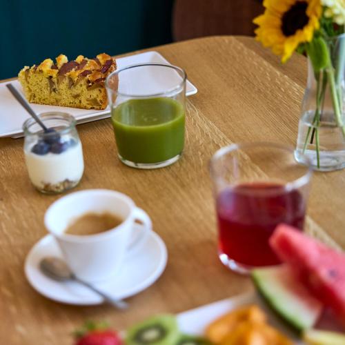 a table with a cup of coffee and a piece of cake at la Sfiora B&B in Cervia