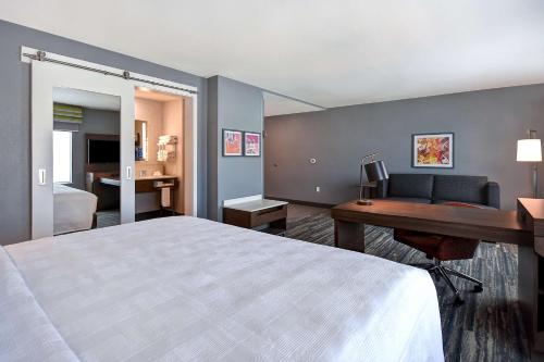 a hotel room with a bed and a desk with a computer at Hampton Inn & Suites Las Vegas Convention Center - No Resort Fee in Las Vegas