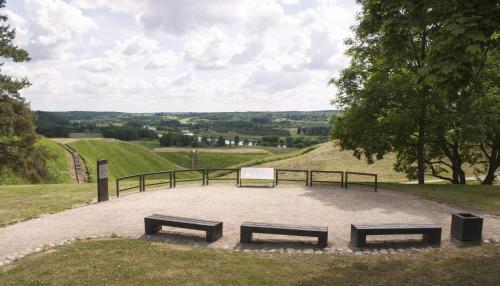 two benches sitting on top of a hill at Gallery Guest Rooms in Kernavė