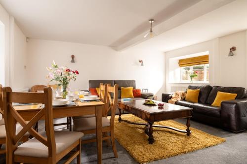 a living room with a table and a couch at Low Barn in Bridlington