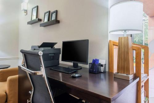 a desk with a computer on top of it at Sleep Inn Sarasota North in Sarasota