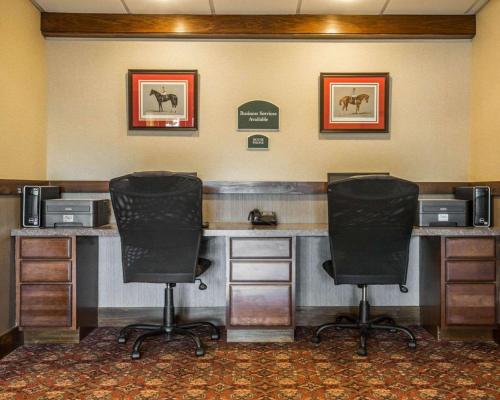 two chairs sitting at a desk in a hotel room at Clarion Inn & Suites at the Outlets of Lake George in Lake George