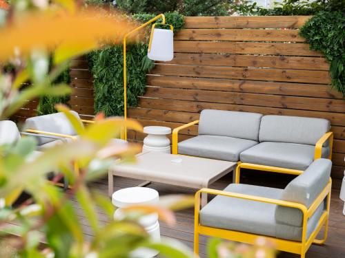 a patio with two chairs and a table at ibis Dijon Gare in Dijon