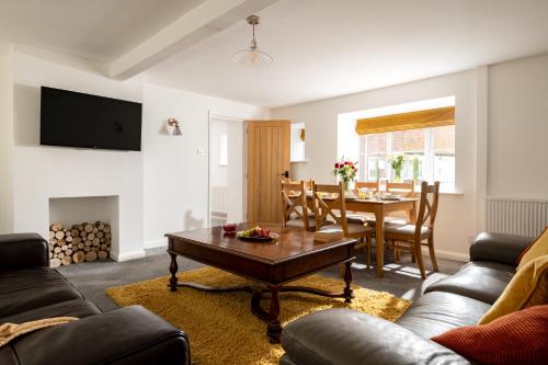 a living room with a table and a dining room at Low Barn in Bridlington
