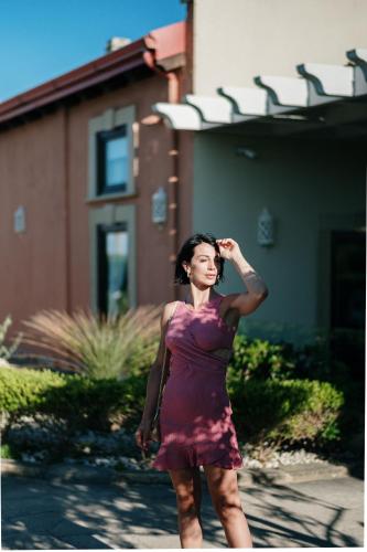 a woman in a purple dress walking down a street at Palascìa Wellness Relais in Otranto