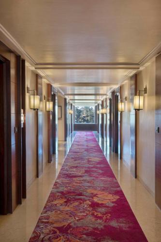 a long hallway with a red carpet in a building at Radisson Kufri in Shimla
