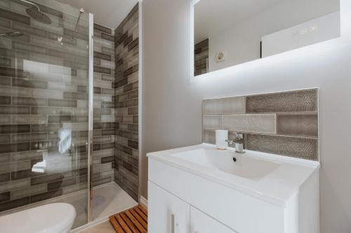 a bathroom with a white sink and a shower at The Woodlands Bed and Breakfast Ironbridge in Ironbridge