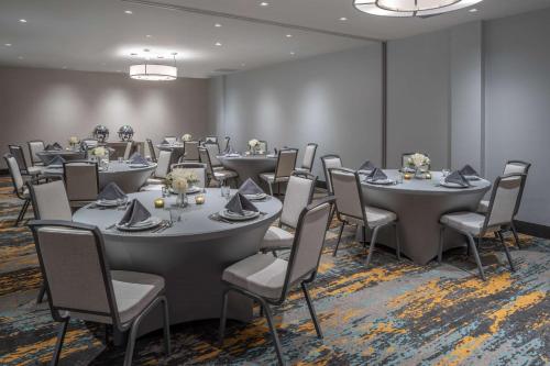 a conference room with tables and chairs and tablesktop at DoubleTree by Hilton Miami North I-95 in Miami