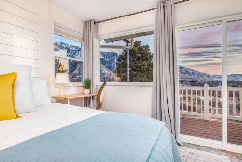 a bedroom with a bed and a large window at Hottub! Views! Basketball! Fireplaces! Mtn Trails in Sandy