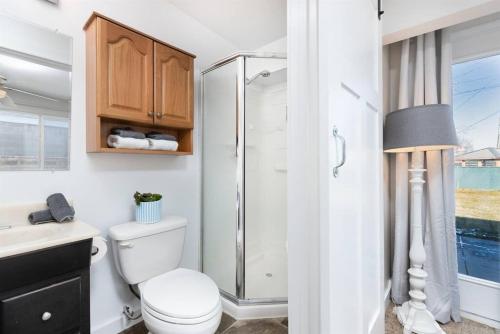 a bathroom with a toilet and a glass shower at Fun In Utah- Hot Tub- Central in Murray
