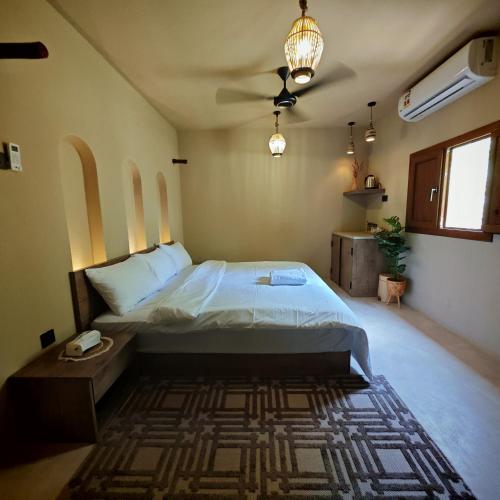 a bedroom with a large bed in a room at نزل عِطره Etra Inn in Nizwa
