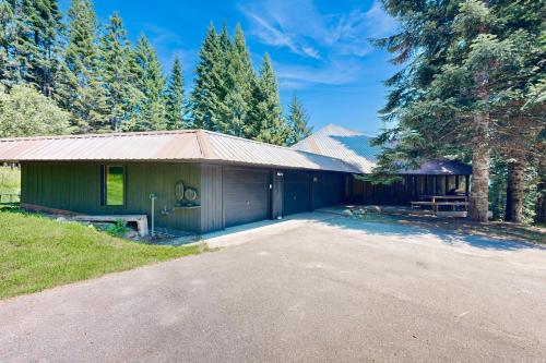 a house with a gravel driveway in front of it at RiverPoint Retreat in Sandpoint