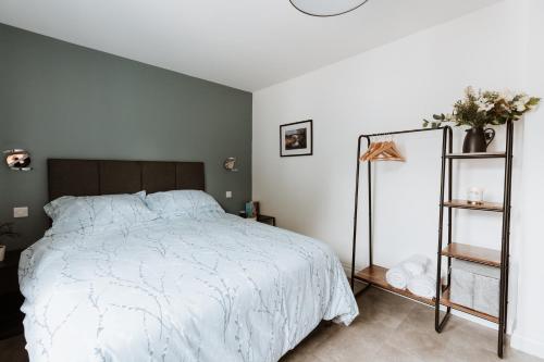 a bedroom with a bed with a white comforter at The Woodlands Bed and Breakfast Ironbridge in Ironbridge