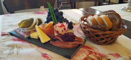 a plate of food on a table with a basket of bread at Hotel Restaurant Alte Stadtmauer in Beilstein