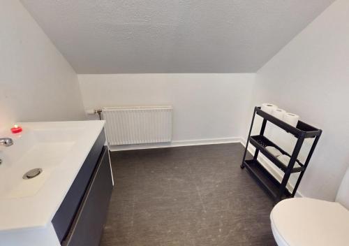 a bathroom with a white sink and a toilet at Entire House in the City, 3 big bedroom with 4 Bed in Hobro
