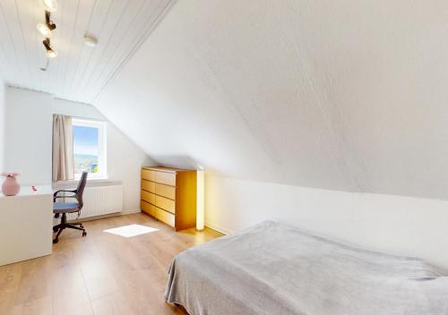 a bedroom with a bed and a desk and a chair at Entire House in the City, 3 big bedroom with 4 Bed in Hobro