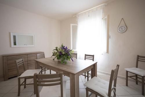 a dining room with a wooden table and chairs at Il Colle affittacamere in Crespina