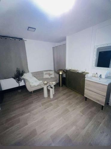 a room with a bed and a sink and a table at Loft ravissant 45m2 Jacuzzi RVB NIGHT 2 in Amiens