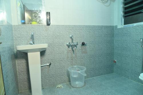 a bathroom with a sink and a toilet at Hotel Air Inn in Guwahati