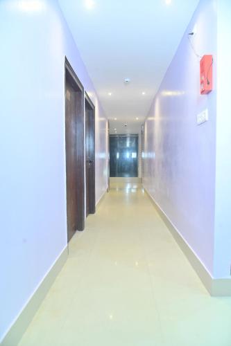an empty corridor of a building with doors and a wall at Hotel Air Inn in Guwahati