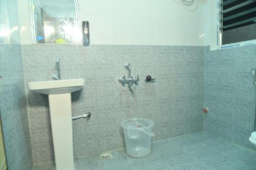 a bathroom with a sink and a toilet at Hotel Air Inn in Guwahati
