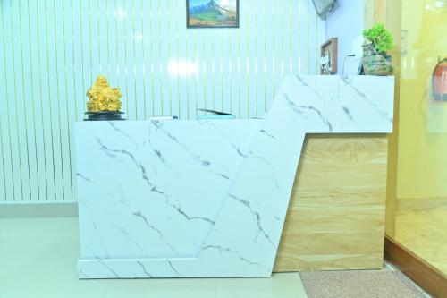a white marble counter with a trophy on top at Hotel Air Inn in Guwahati