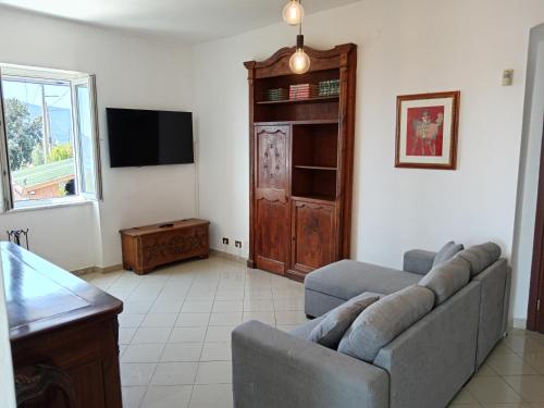 a living room with a couch and a tv at Orizzonte spezzino in La Spezia