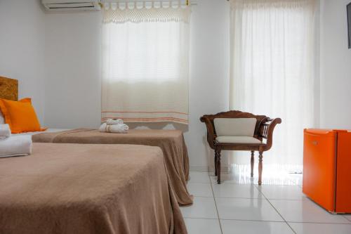Ένα ή περισσότερα κρεβάτια σε δωμάτιο στο Araruna Hotel