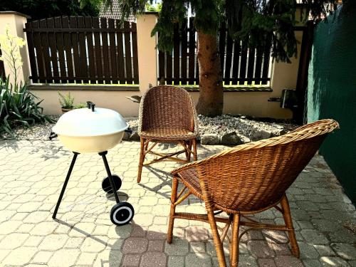 two chairs and a barbecue grill on a patio at Rodinný dům Poděbrady in Poděbrady