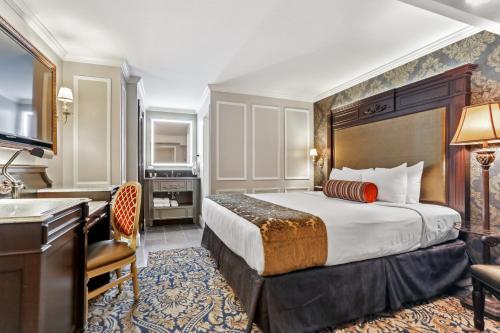 a hotel room with a bed and a desk at Place D'Armes Hotel in New Orleans