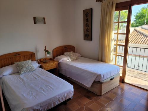 two beds in a room with a window at La Casa del Sol in La Eliana