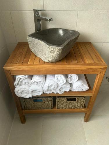 a bathroom sink on a wooden shelf with towels at Home on the Wild Atlantic Way in Newport