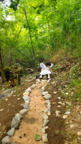 a toy girl in a dress on a dirt road at Areni Lodge in Areni