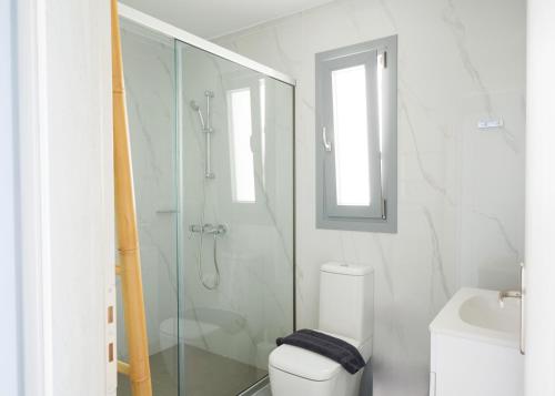 a bathroom with a shower and a toilet and a sink at Blue Sea Paros in Drios