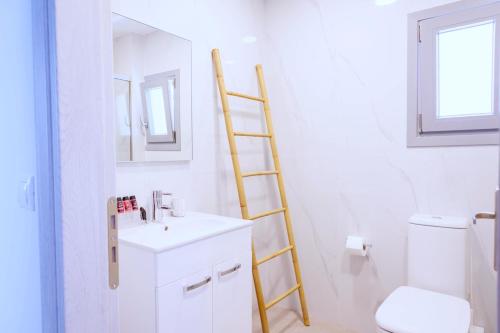 a ladder in a bathroom with a sink and a toilet at Blue Sea Paros in Drios