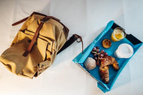 a blue lunch tray with a bag and some food at Stay Hotel Porto Centro Trindade in Porto