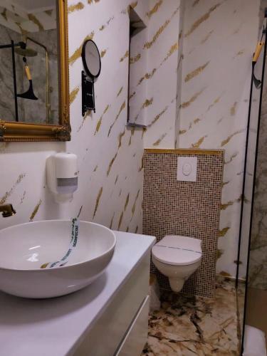 a bathroom with a sink and a toilet at Lemon Breeze in Constanţa