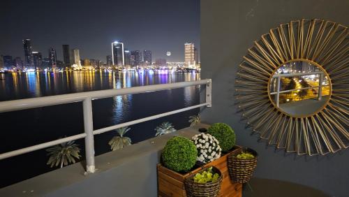 a mirror on a balcony with a view of the city at Luxury Private Rooms in Sharjah