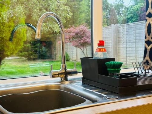 a sink in a kitchen with a window at Home Away Luxury Living - Horley in Horley
