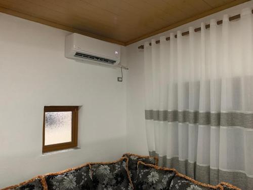 a living room with a couch and a window at Noemi House in Krujë