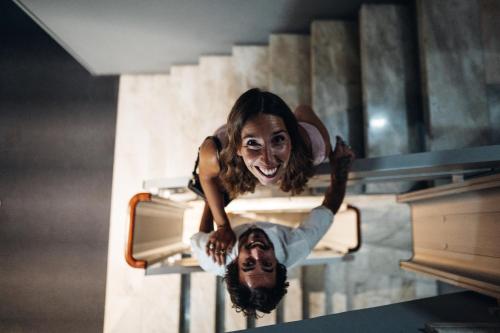 a girl is smiling while sitting on a table at Stay Hotel Porto Centro Trindade in Porto