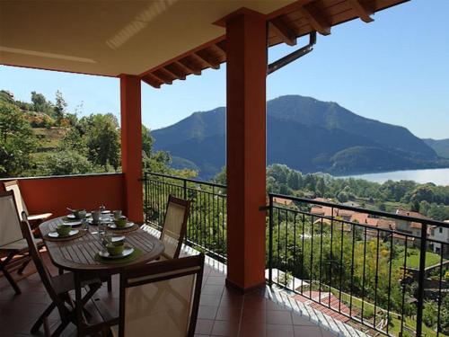 a table and chairs on a balcony with a view at Arcobaleno Dante in Arizzano