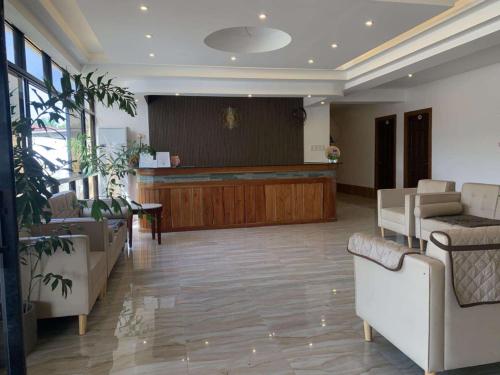 a large waiting room with a stage and couches at DonRio Hotel Siquijor in Siquijor