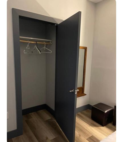 a black door with hangers in a room at Cozy Room in Newark