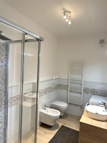 a bathroom with a shower and a toilet and a sink at Casa Brunilde in Pisogne