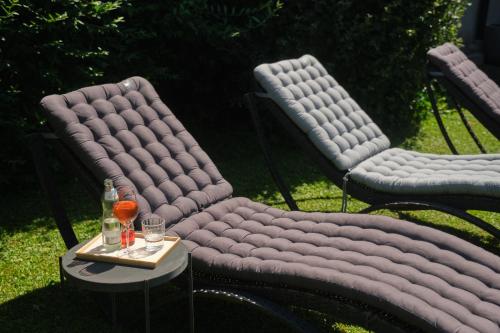 two chairs with a table with two glasses of wine at Santner, Hotel in Eugendorf