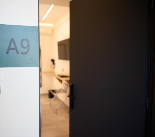 an open door to a room with aac sign at Ocean 11 Hotel in Skiathos Town