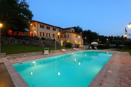 a large swimming pool in front of a house at Casa Vacanze Residenza Bocci in Foligno