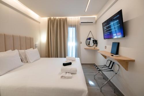 a hotel room with a bed and a desk with a computer at Ocean 11 Hotel in Skiathos Town